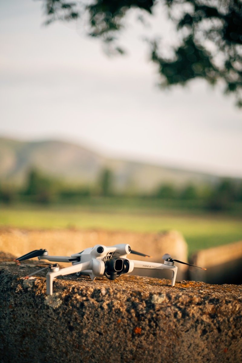 a small white remote controlled device sitting on top of a rock